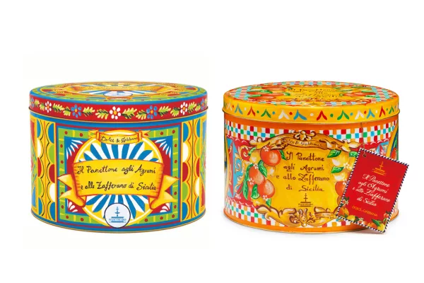 Scatole da collezione di panettone Dolce &amp; Gabbana con agrumi di Sicilia e zafferano di Fiasconaro, decorate con motivi colorati ispirati al tradizionale carretto siciliano.