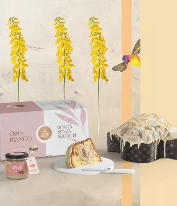Colombe de Pâques Oro Bianco de Fiasconaro avec sa couverture de chocolat blanc et amandes, présentée avec son pot de crème et son spalmino