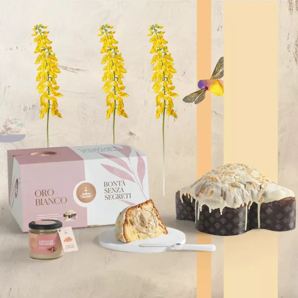 Colombe de Pâques Oro Bianco de Fiasconaro avec sa couverture de chocolat blanc et amandes, présentée avec son pot de crème et son spalmino